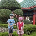Children posing in front of some Chinese Gardens