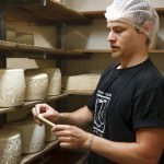 Sampling the cheese from the wheels